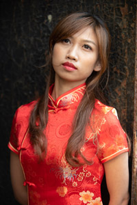 フリー写真 錆びた鉄板の前に立つチャイナドレスを着た台湾人女性