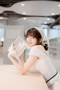 フリー写真 図書館の机に肘をつく台湾人女性