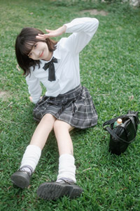 フリー写真 座りながら敬礼のポーズの女子学生