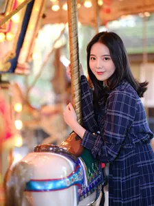 フリー写真 メリーゴーランドの前に立つ台湾人女性