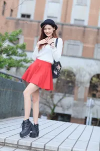 フリー写真 手を胸にあてて立つミニスカート姿の台湾人女性